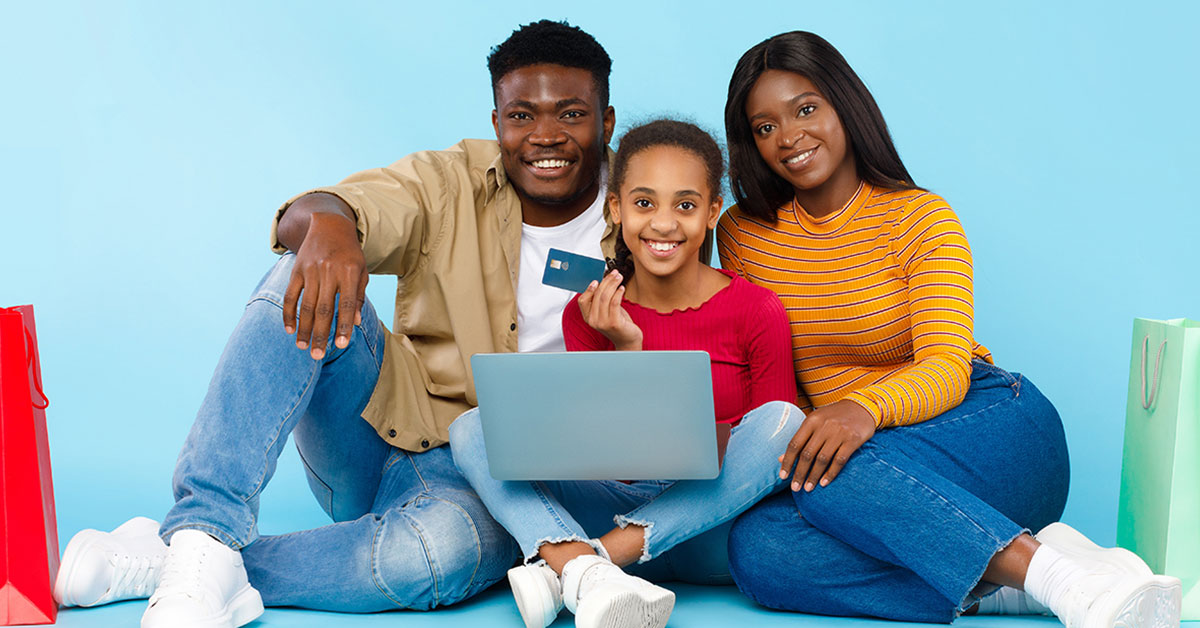 Parents with young teenage daughter showing her how to use her checking account and debit card online.