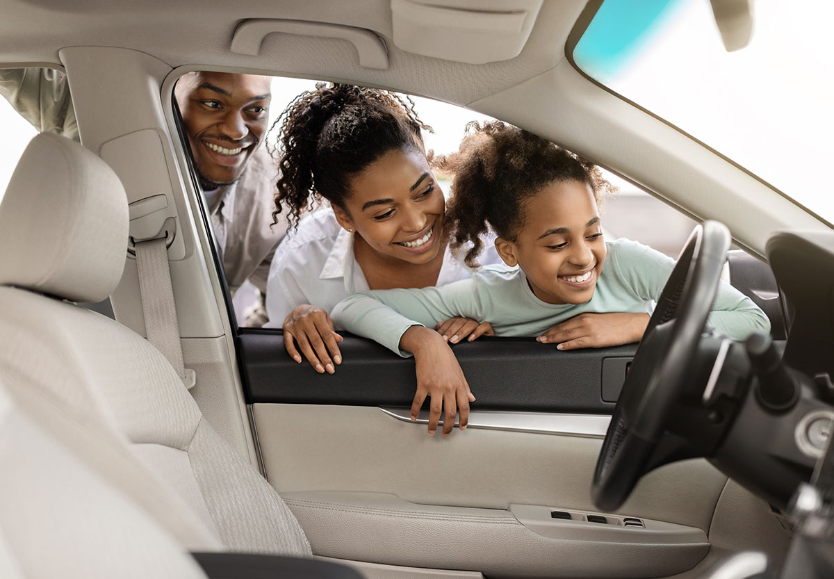 a family looking inside a car