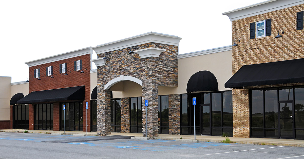 Strip mall with several empty storefronts for commercial real estate development.