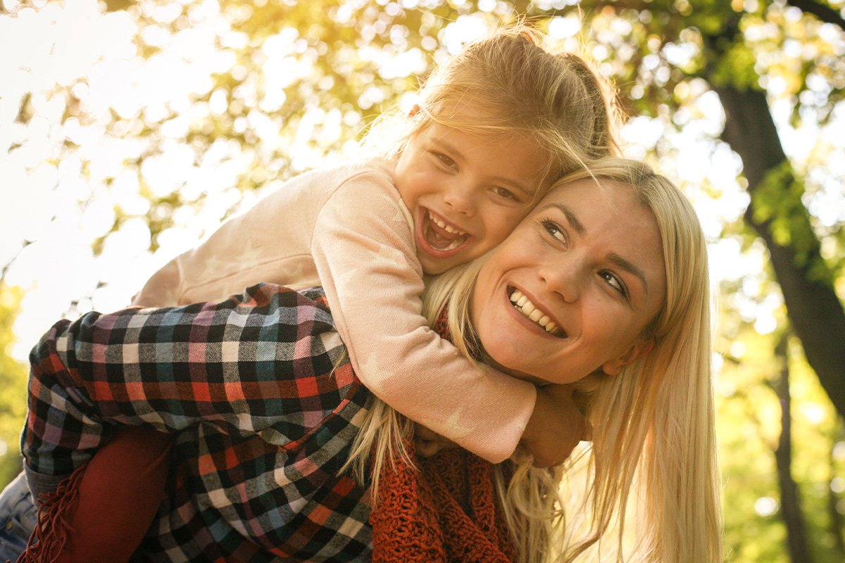 A woman with daughter smiling
