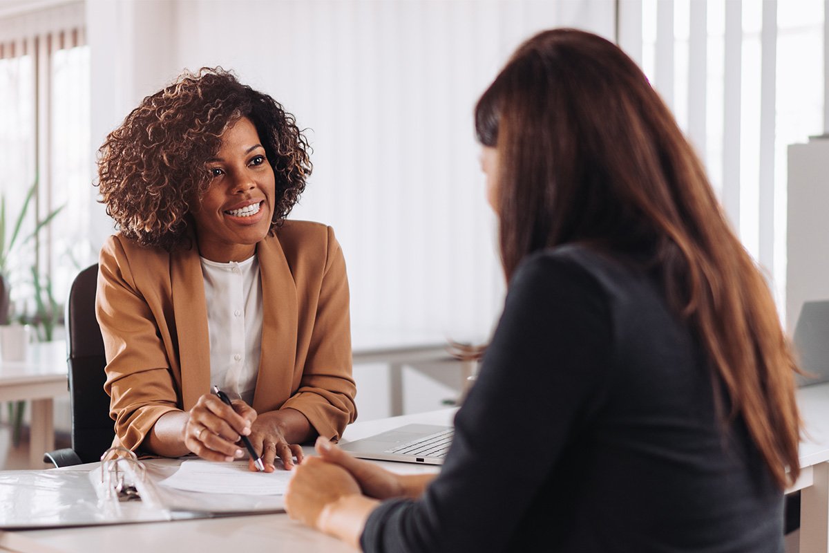 woman conversing with a female executive