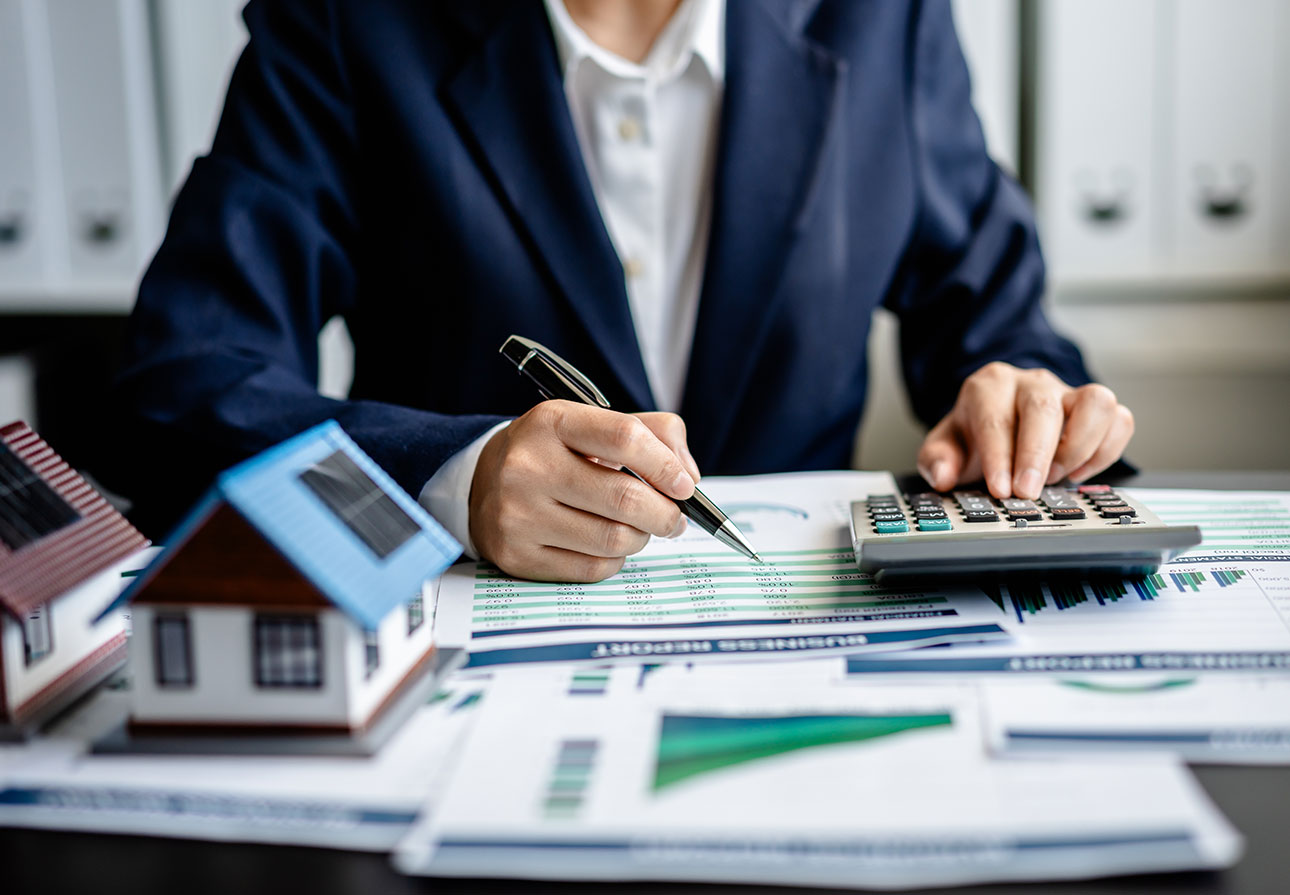 a person sitting at their desk and running mortgage-related calculations.