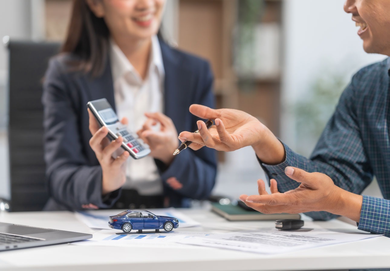 a woman holding up a calculator while pointing at it.