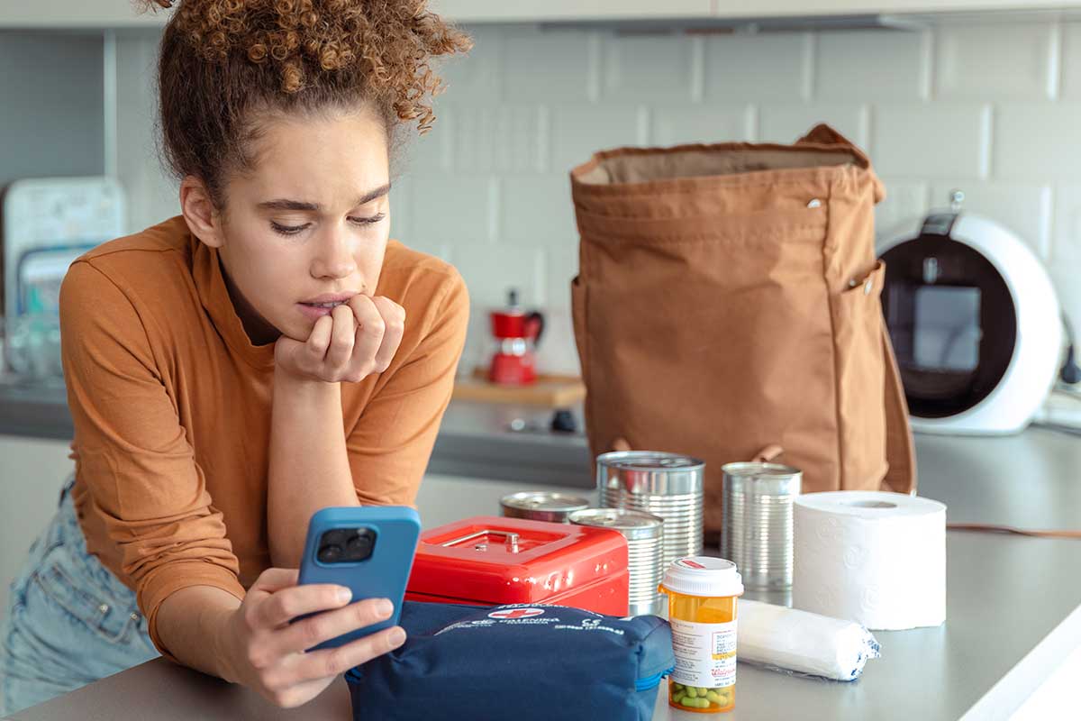 Woman with Groceries Checks Phone