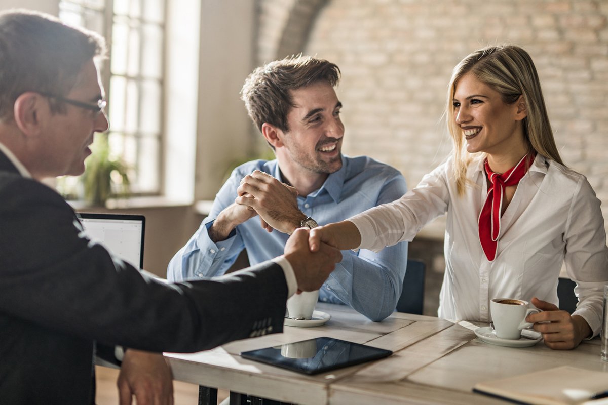 woman shaking the hand of a mortgage loan officer