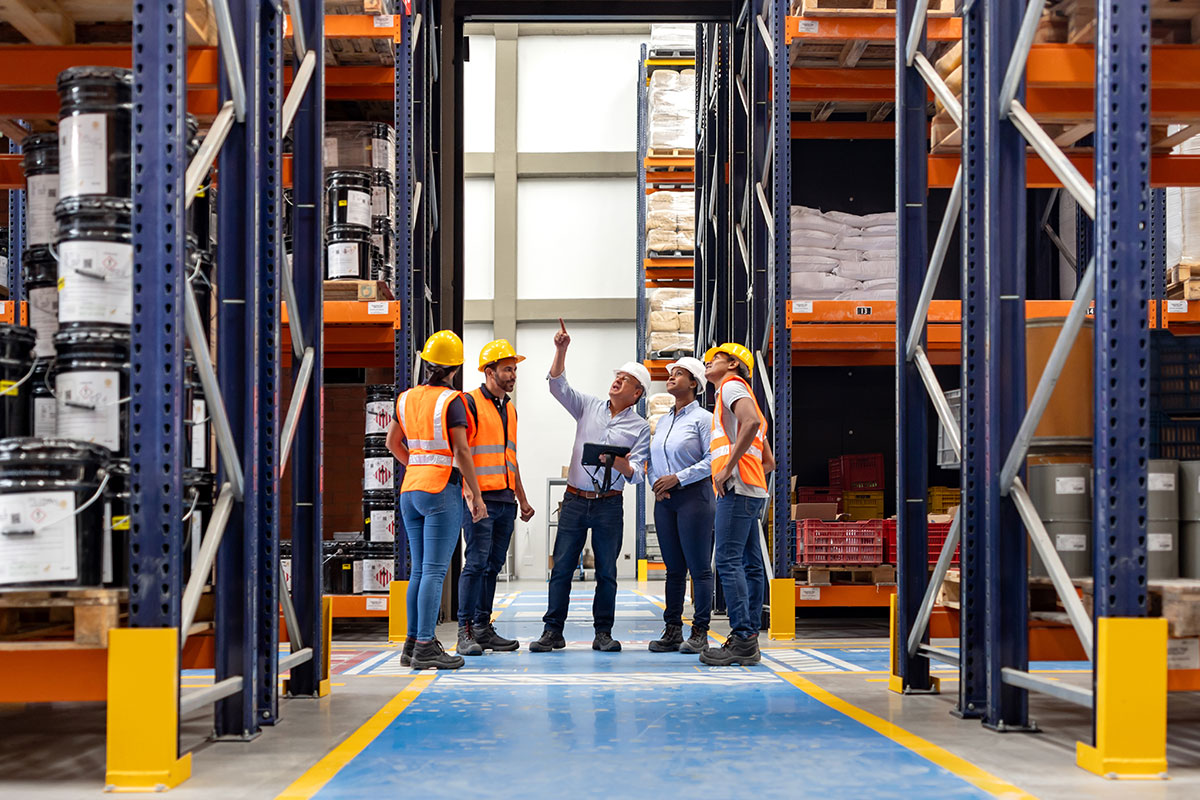 Workers with Hard Hats in Warehouse