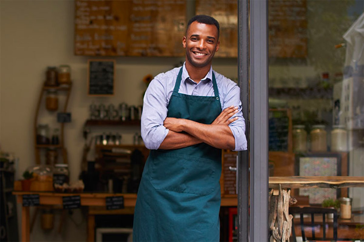 Business owner standing at storefront