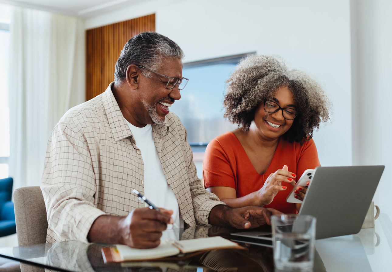 a happy, older couple planning for retirement.