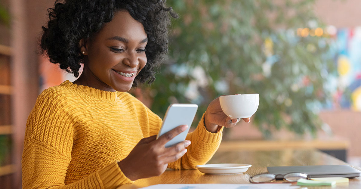 Woman reviewing her credit report at a coffee shop