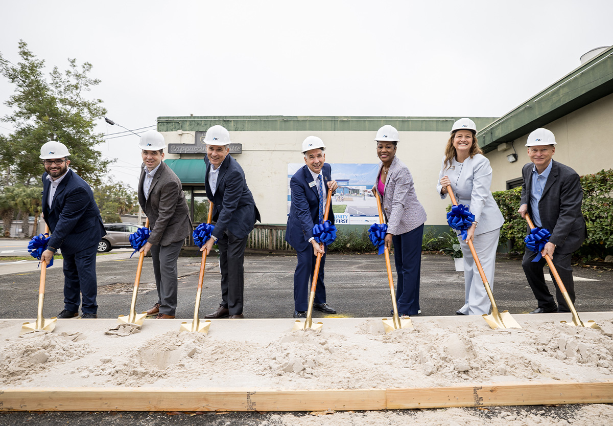 Community First leadership team smiles with shovels in hand