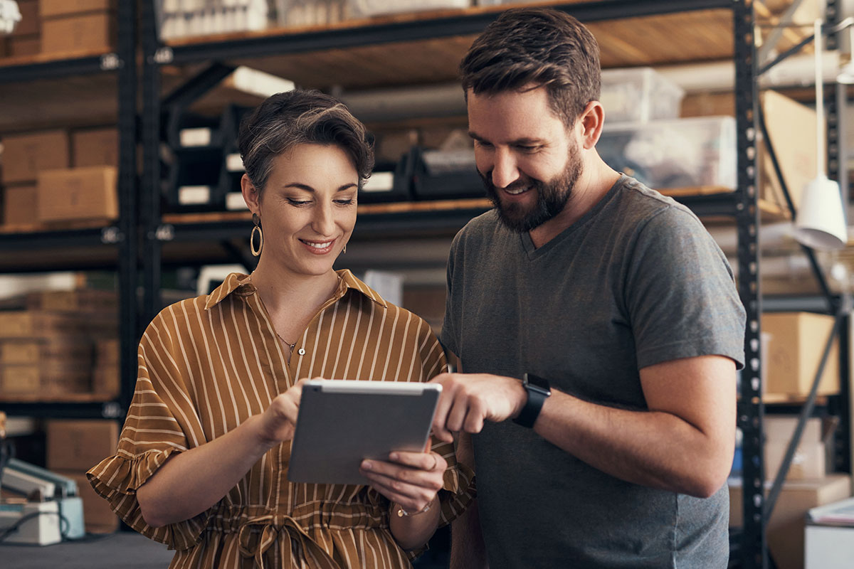 Young Professionals Read Info on Tablet Screen